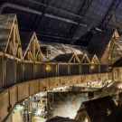 Inner Atrium - Third floor hotel balconies. Hand hewed railroad timbers utilized in trusses, wall decor and support systems.