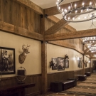 Prefunction Hallway - Hand hewed railroad timbers. Pecky Cypress ceiling and floor wall treatment.