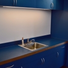 Kitchen counter, upper and lower cabinets of meeting room.